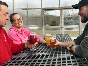 People enjoying beers in greenhouse
